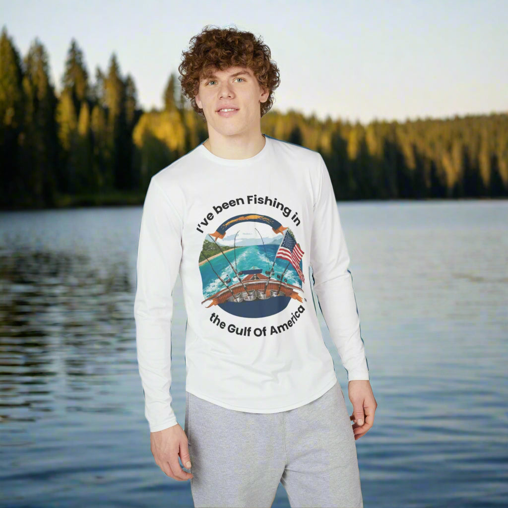 Long sleeve UV fishing shirt with “I’ve Been Fishing in the Gulf of America” printed on the chest, worn by an angler casting on the Gulf shoreline