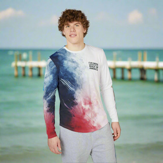 Men’s patriotic UV protection long sleeve fishing shirt featuring red, white, and blue colors with “I’ve Been Fishing the Gulf of America” text, worn by an angler on the Gulf Coast