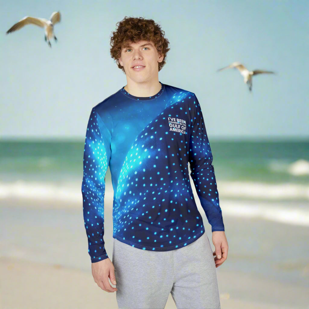 Men’s UV protection long sleeve fishing shirt with whale shark skin pattern and “I’ve Been Fishing the Gulf of America” text, worn on the Gulf Coast shoreline
