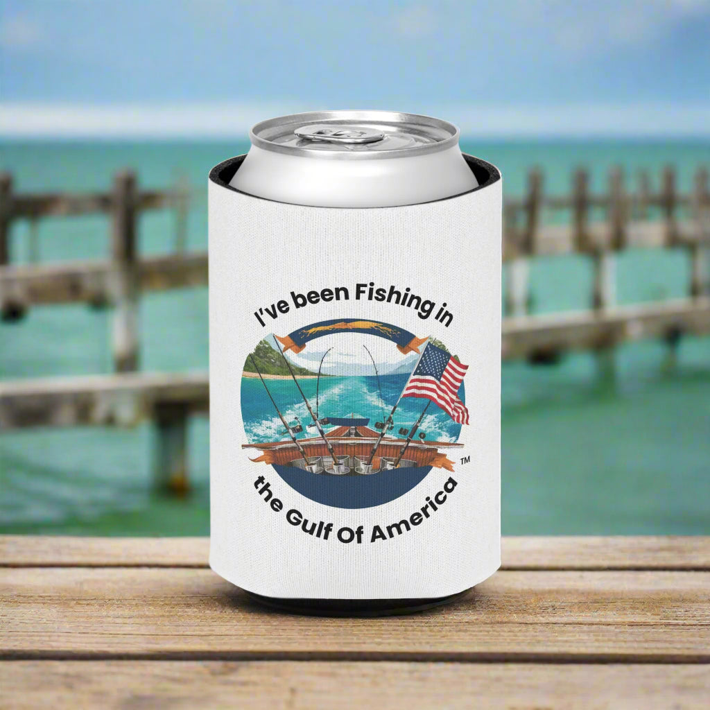 Can cooler with “I’ve Been Fishing in the Gulf of America” text, wrapped around a cold drink on a boat deck with Gulf water in the background