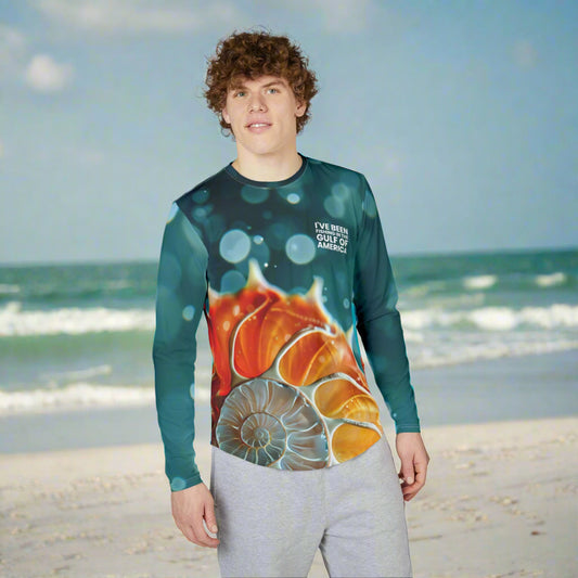 Men’s UV protection long sleeve fishing shirt featuring an all-over nautilus shell pattern and “I’ve Been Fishing the Gulf of America” text, worn by an angler near the Gulf